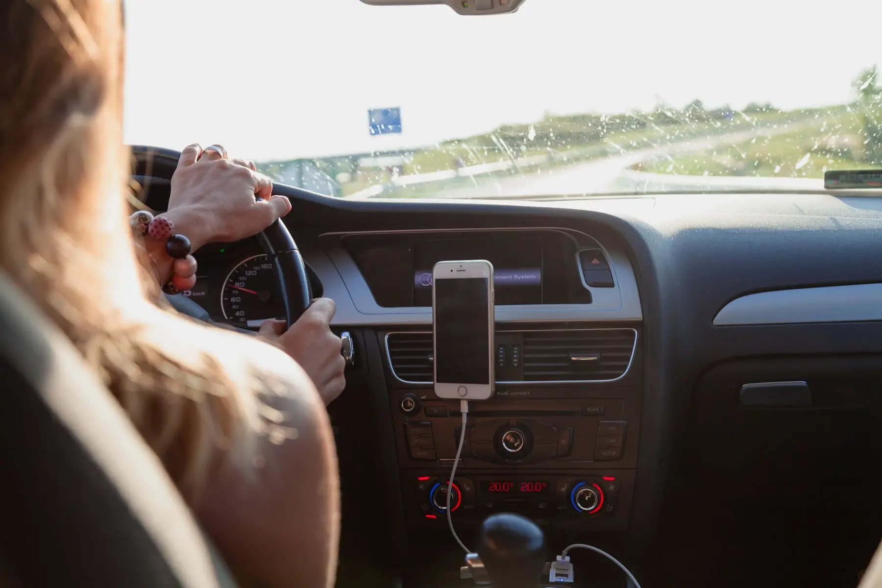 A phone mounted on a car dashboard showing the route during a trip