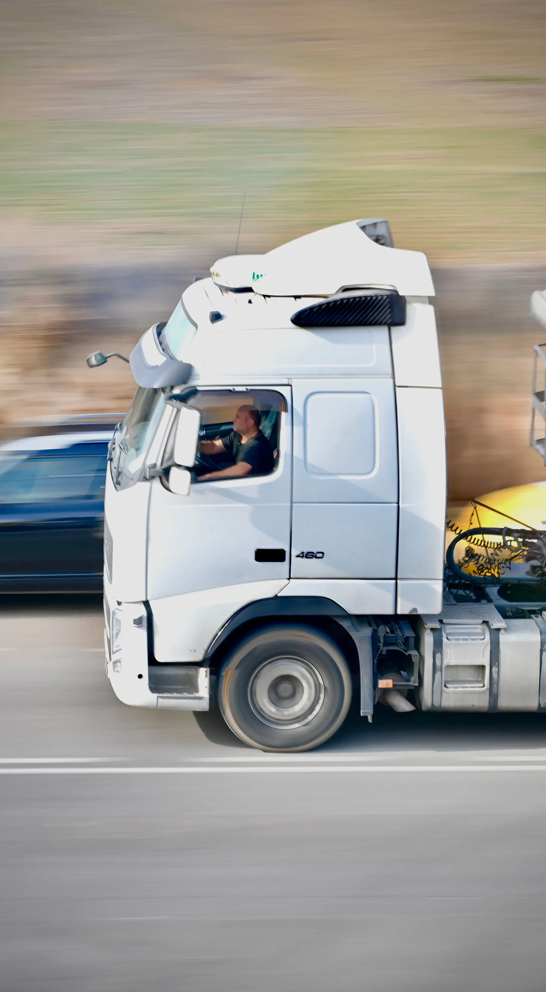 A truck driver at the wheel of his cab, the kind of vehicle owner who publishes runs on HeyGo